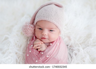 Cute Awake Newborn In Knitted Hat And Decorated Blanket