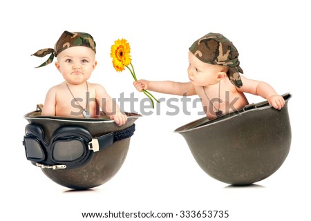 Cute babies inside an old military helmet