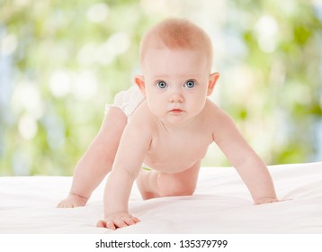 Cute Baby With Beautiful Blue Eyes On The Nature Background