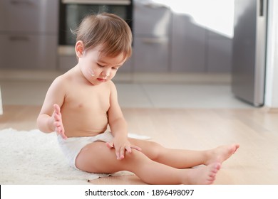 Cute Baby Boy Applying Lotion Cream On Face And Body After Bathing. Mixed Race Asian-German Infant Protection Skin Concept.