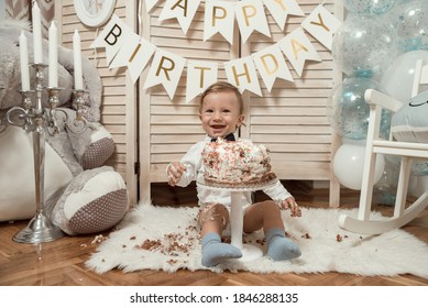 cute baby boy with birthday cake decoration. kids 1st birthday.