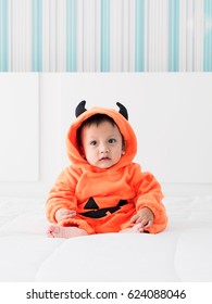 Cute Baby Boy Dressed In Pumpkin Costume