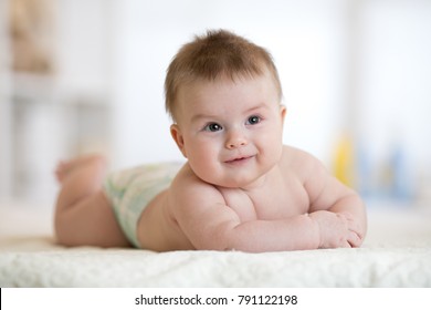 Cute Baby Boy Laying Down On Bed In Nursery