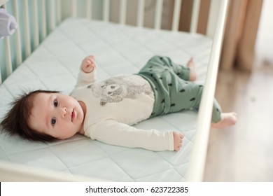 Cute Baby Boy Lying In His Crib