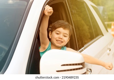 Cute Baby Boy On Driver Seat With Hands Head Outside Expressing Hooray Ready For Trip.kid Have Fun While Parents Embarking.road Trip Travel Tourism Concept.opened Car Door Window Sunshine Summer Time