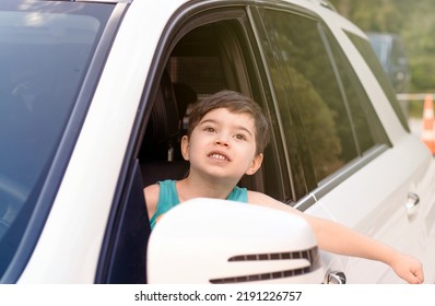 Cute Baby Boy On Driver Seat With Hands Head Outside Expressing Hooray Ready For Trip.kid Have Fun While Parents Embarking.road Trip Travel Tourism Concept.opened Car Door Window Sunshine Summer 