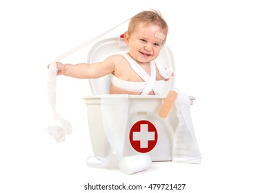 Cute Baby Boy Playing With Bandages In A First Aid Kit Box.