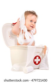 Cute Baby Boy Playing With Bandages In A First Aid Kit Box.