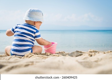Cute Baby Boy Playing With Beach Toys