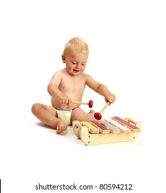 A Cute Baby Boy Playing A Xylophone Musical Instrument Isolated On A White Background