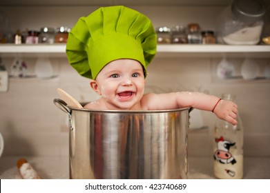 Cute baby chef in a huge pot