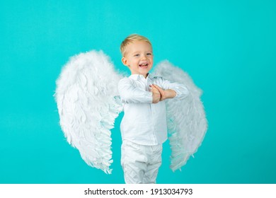 Cute Baby Child With Angel Wings, Isolated On Blue