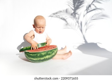 Cute Baby, Child, Kid Emotins. Funny Toddler Boy Playing With Ripe Watermelon, Healthy Fruit Snack On White Background, Hot Summer Day. Organic Vegan Healthy Diet, Feeding, Solid Food Concept.