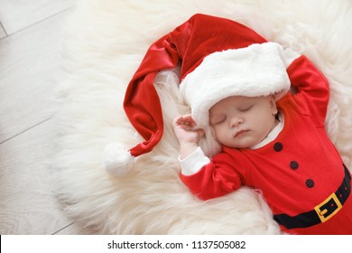 Cute Baby In Christmas Costume Sleeping On Fur Rug