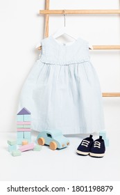 Cute Baby Clothes Hanging On The Rack. Organic Cotton Kids Apparel Mockup.