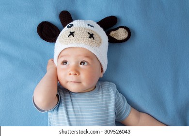 Cute Baby In A Cow Hat On Blue Blanket