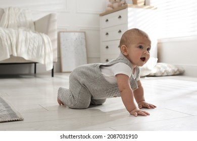 Cute baby crawling on floor at home - Shutterstock ID 2087031910