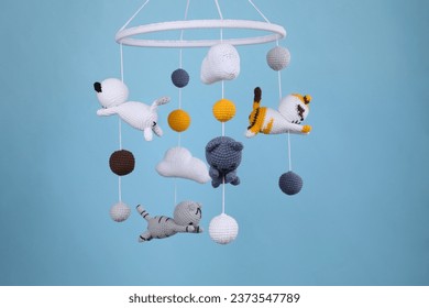 Cute baby crib mobile on light blue background - Powered by Shutterstock - Get 15% off with code: PIKWIZARD15