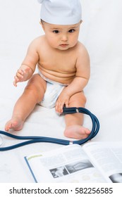 Cute Baby Doctor With A Stethoscope And A Book