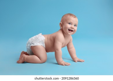 Cute baby in dry soft diaper crawling on light blue background - Shutterstock ID 2091286360