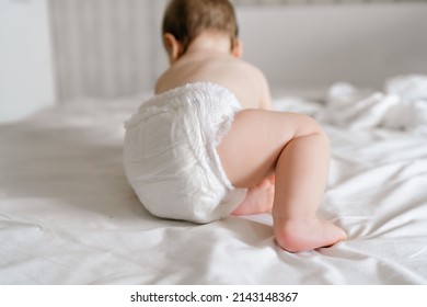 Cute baby in dry soft diaper on white bed at home, back view - Powered by Shutterstock