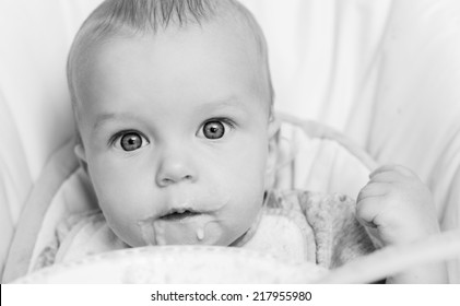 Cute Baby Eating Porridge On A White Background  ( Black And White )