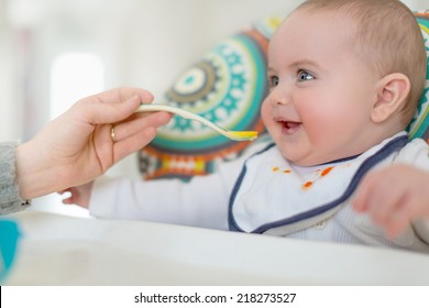 Cute baby eating puree