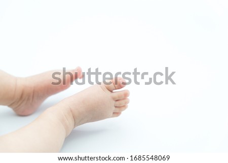 Cute baby feet on white background