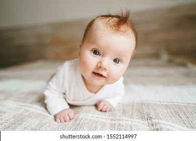 Cute Baby Ingwer Haar Nahaufnahme krabbeln auf dem Bett lächelnd bezaubernden Kind Portrait Familie Lifestyle 3 Monate alten Kind