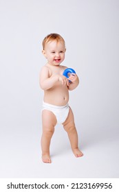 Cute Baby Girl In A Diaper Stands In Full Height Isolated On A White Background