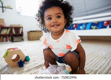 Cute Baby Girl Having Fun In Playroom With Toys