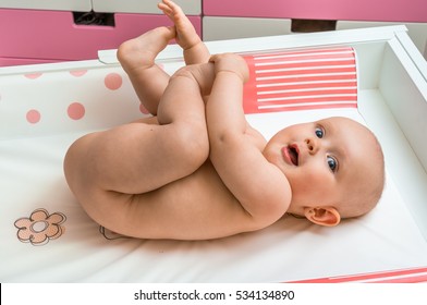 Cute Baby Girl Lying On Changing Pad And Waiting For A Clean Diaper