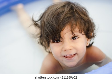 Cute Baby Girl In A Plastic Swiming Pool In A Low Depth Of Field Image