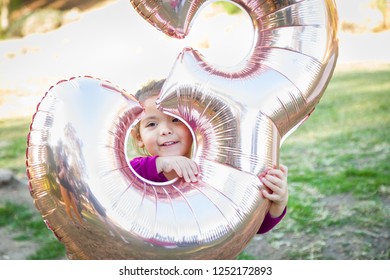 Cute Baby Girl Playing With Number Three Mylar Balloon Outdoors.