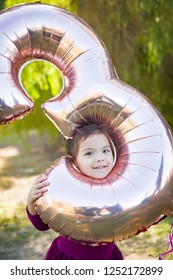 Cute Baby Girl Playing With Number Three Mylar Balloon Outdoors.