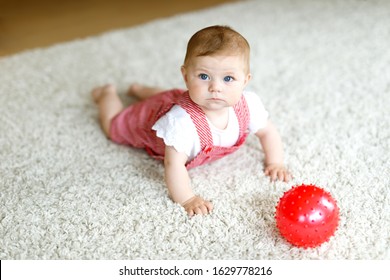 Cute Baby Girl Playing With Red Gum Ball.