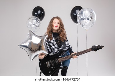 Cute Baby Girl Rock Star Playing Electric Guitar And Singing Song Surrounded By Balloons