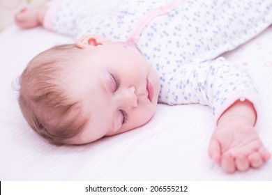 Cute Baby Girl Sleeping In Her Crib.