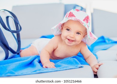 Cute Baby Girl In A Sun Hat Laying On A Beach Lounge Chair