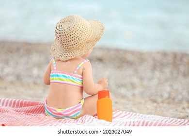 Cute Baby Girl With Sunscreen Cream On Beach