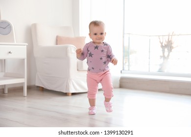 Cute Baby Girl Walking In Room At Home