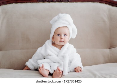 Cute Baby Girl In White Bathrobe