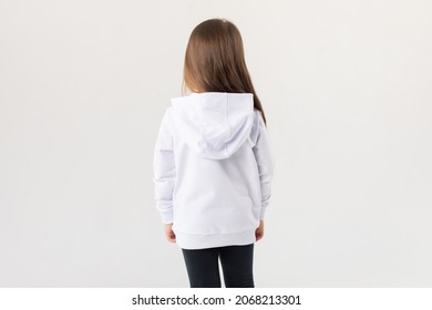 Cute Baby Girl In A White Blank Hoodie On A White Background. Kids Hoodies Mockup.