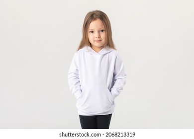 Cute Baby Girl In A White Blank Hoodie On A White Background. Kids Hoodies Mockup.