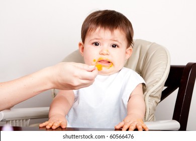 Cute Baby Infant Boy Girl Expresses Dislike Disgust For Food Fed By Spoon.