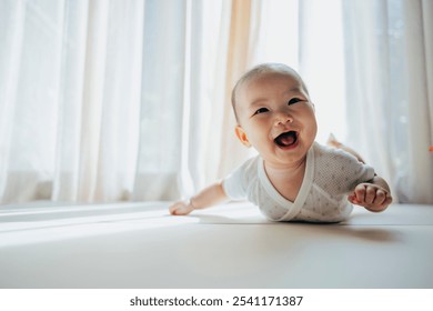 A cute baby lies on the bed, smiling and looking directly at the camera with bright, curious eyes. Their joyful expression captures a moment of pure happiness and innocence. - Powered by Shutterstock