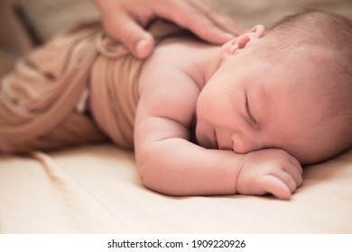 Cute Baby Lies On Blanket. New Born Baby Smilies Happy In A Dream And Try Try Raise Head