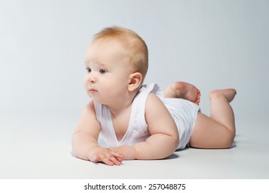 Cute baby lying in diaper  on white background 