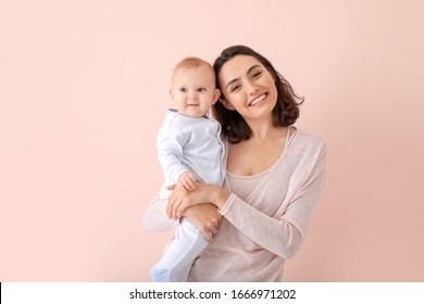 Cute Baby With Mother On Color Background