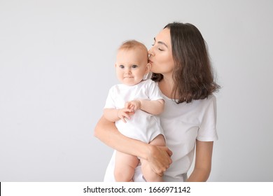 Cute Baby With Mother On Light Background